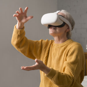 virtual reality. VR, future, gadgets. senior woman playing game in virtual reality glasses and holds joysticks at home